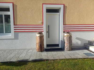 a white door in the side of a building at Appartamento Vale e Schena Cortina D'Ampezzo in San Vito di Cadore