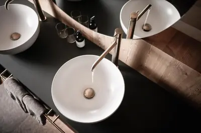 a man standing in a kitchen holding a bowl at OLM Nature Escape - Eco Aparthotel in Campo Tures