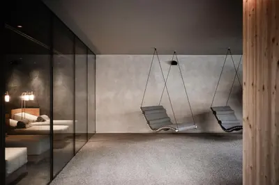 a swimming pool with escalators in a building at OLM Nature Escape - Eco Aparthotel in Campo Tures