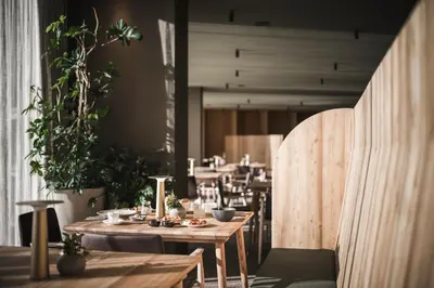 two chairs in a room with a bed at OLM Nature Escape - Eco Aparthotel in Campo Tures