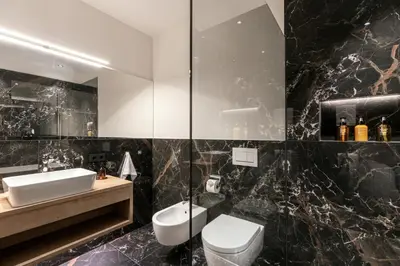 a bathroom with a white toilet and a sink at Chalet Samont in Laion