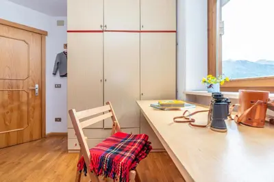 a kitchen with a wooden counter and a wooden chair at Sport & natura in Trentino! in Vigo di Fassa