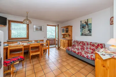 a living room with a couch and a table at Sport & natura in Trentino! in Vigo di Fassa