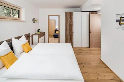 a bedroom with two large white beds in it at Appartement Irene in Caldaro