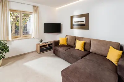 a living room with a couch and a tv at Appartement Irene in Caldaro
