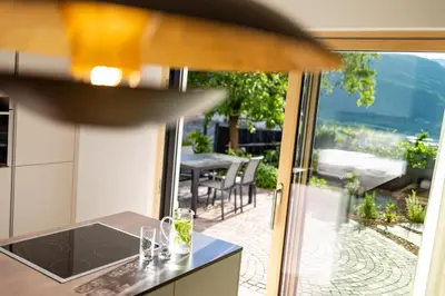 a kitchen with a table and a view of a patio at Appartement Irene in Caldaro