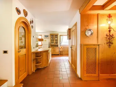 a home with a wooden door and stairs at Chalet Cesa Galadriel-3 by Interhome in Penia