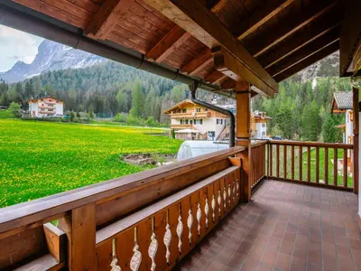a bedroom with a large bed in a cabin at Chalet Cesa Galadriel-3 by Interhome in Penia