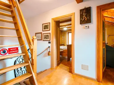 a bedroom with a bed and a blue dresser at Chalet Cesa Galadriel-3 by Interhome in Penia