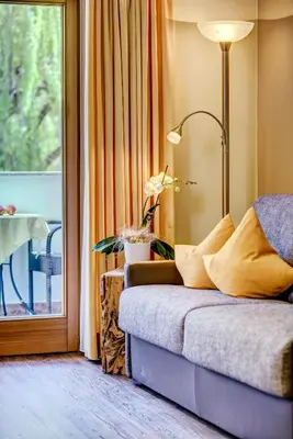 a living room with a couch and a window at Alpenhof Lodge in Saltusio