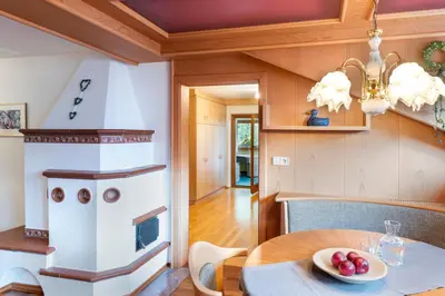 a kitchen with a table and a stove at Alpenhof Lodge in Saltusio
