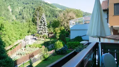 a kitchen with white cabinets and a sink at Alpenhof Lodge in Saltusio
