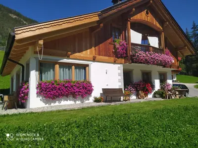 a house with flowers on the side of it at Agriturismo La Flu in San Martino in Badia