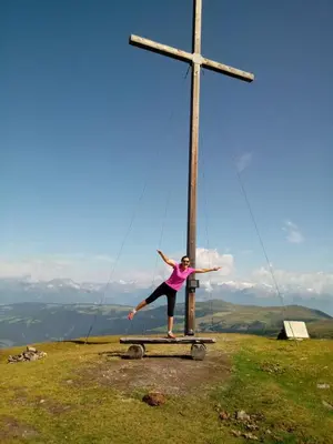 a woman standing on a platform in front of a cross at Agriturismo La Flu in San Martino in Badia
