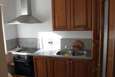 a kitchen with a sink and a stove at Condominio Zorzi in Moena