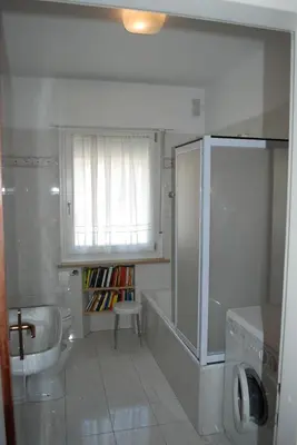 a bathroom with a tub and a sink and a toilet at Condominio Zorzi in Moena
