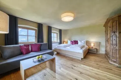 a large bedroom with a bed and a couch at Lothof in Schenna