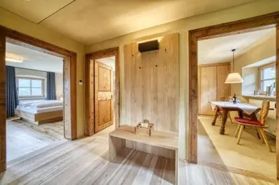 a bathroom with a tub and a sink and a table at Lothof in Schenna