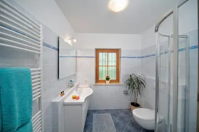 a white bathroom with a sink and a toilet at Lothof in Schenna