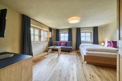 a large room with a bed and a couch at Lothof in Schenna