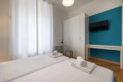 a bedroom with a large white bed with towels on it at Mia Rooms - Room with private bath Bolzano Center in Bolzano