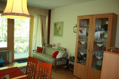 a living room with a couch and a glass cabinet at Ferienwohnung Thermen in Merano