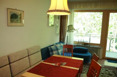 a living room with a table and a couch at Ferienwohnung Thermen in Merano
