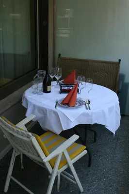 a table with a white table cloth and wine glasses at Ferienwohnung Thermen in Merano