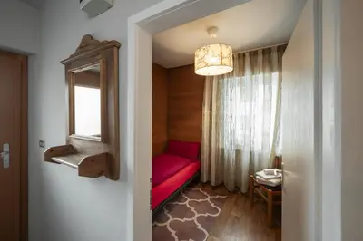 a red couch in a room with a window at Villa Ginestra 3 in Moena