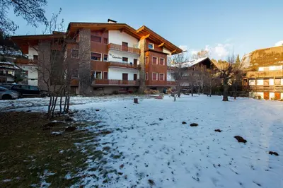 a snow covered yard in front of a building at Villa Ginestra 3 in Moena