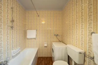 a bathroom with a tub and a toilet and a sink at Villa Ginestra 3 in Moena