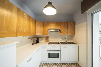 a kitchen with wooden cabinets and a sink at Villa Ginestra 3 in Moena