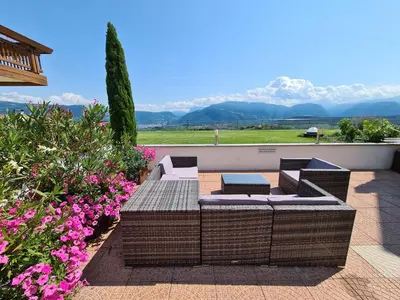 a red flower in the middle of a green plant at DAS MATSCHER Residence & Garden Hotel in Appiano sulla Strada del Vino
