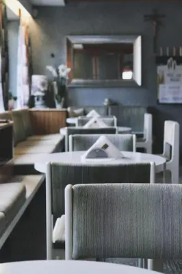 a row of tables and chairs in a restaurant at Café Rudi Living in Parcines