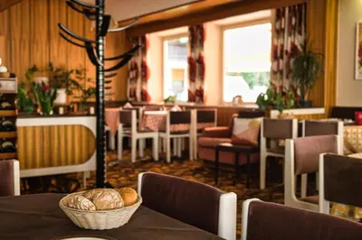 a restaurant with a table with bread on it at Café Rudi Living in Parcines