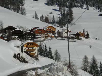 a group of houses in a snow covered mountain at Casa Gogn in San Vigilio Di Marebbe