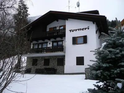 a building with the word tennent on it in the snow at Ciasa Torneri in San Vigilio Di Marebbe