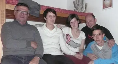 a group of people sitting on a couch at Ciasa Torneri in San Vigilio Di Marebbe
