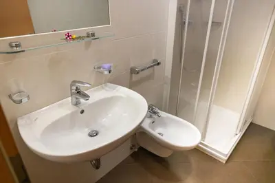 a bathroom with a sink and a shower at Cone da Val in San Vigilio Di Marebbe