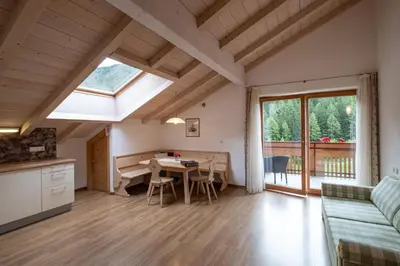 a kitchen and living room with a table and a window at Messnerhof, Durnholz in Valdurna