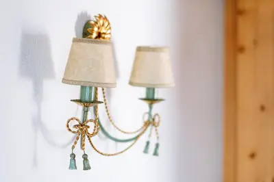 two lamps hanging on a wall in a room at Residence Alpenrose in Rasùn di Sotto