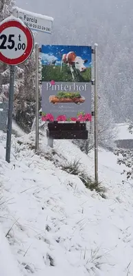a sign in the snow with a bird on it at Pinterhof in San Vigilio Di Marebbe