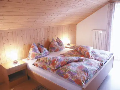 a bedroom with a bed with pillows on it at Pinterhof in San Vigilio Di Marebbe
