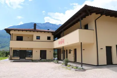 a large building with a mountain in the background at Pomaria in Caldaro