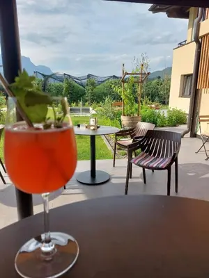 a drink sitting on a table on a patio at Pomaria in Caldaro