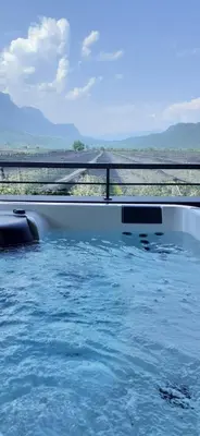 a swimming pool with blue water and a railing at Pomaria in Caldaro