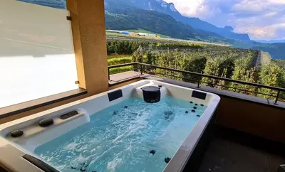 a bath tub with a view of a mountain at Pomaria in Caldaro