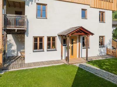a house with a porch and a deck at Eco Chalet Olival in Braies