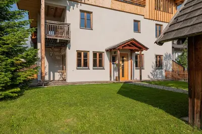 an exterior view of a house with a yard at Eco Chalet Olival in Braies