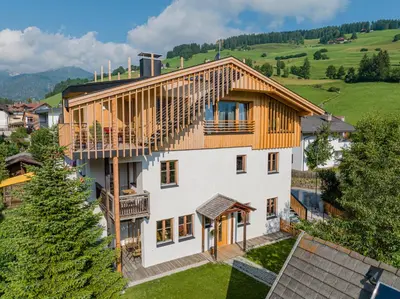an external view of a house with a wooden roof at Eco Chalet Olival in Braies